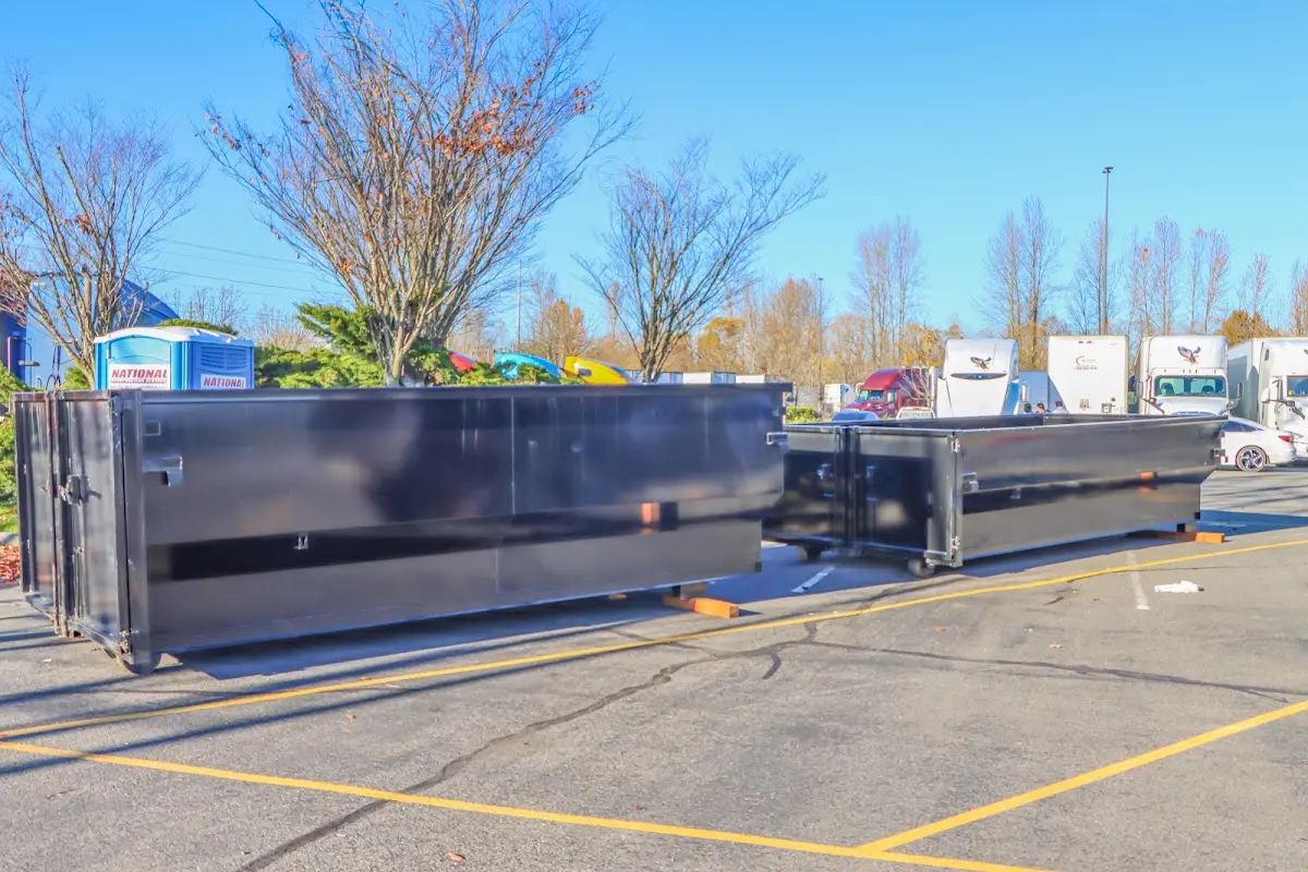 Professional dumpster rental service with roll-off container on residential driveway in Holyoke